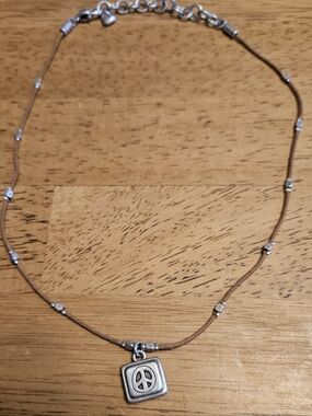 Brighton Silver Peace Pendant Necklace on Brown Cord